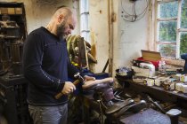 Man standing in a shoemaker's workshop — Stock Photo