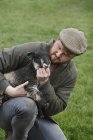 Farmer holding a young lamb — Stock Photo