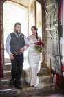 Bride and groom entering church. — Stock Photo