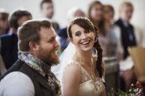 Smiling bride and groom at church — Stock Photo