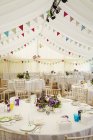 Wedding marquee with set tables — Stock Photo