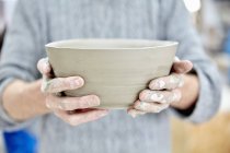 Person holding clay pot — Stock Photo