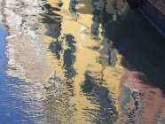 Reflection of houses with painted walls — Stock Photo