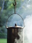 Cast iron pot on campfire — Stock Photo