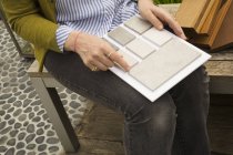Woman holding tile samples. — Stock Photo