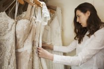 Woman choosing wedding dresses — Stock Photo