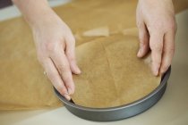 Person lining baking paper. — Stock Photo