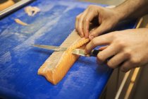 Cutting a fillet of salmon — Stock Photo