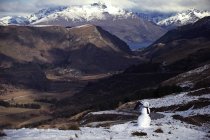 Mountain valley with snowman — Stock Photo
