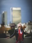 Woman dancing on city rooftop — Stock Photo