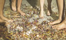 Feet walking on carpet covered in confetti. — Stock Photo