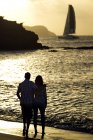 Couple standing on sandy beach — Stock Photo