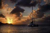 Sailingboat on ocean at sunset. — Stock Photo