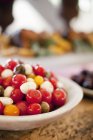 Red and orange tomatoes in bocconcini salad — Stock Photo