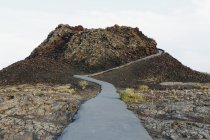 Paved pathway up into lava fields — Stock Photo