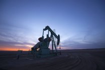 Pumpjack at oil drilling site — Stock Photo
