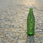 Glass bottle of water in Black Rock Desert in Nevada — Stock Photo