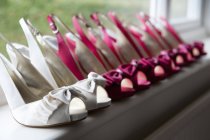 Row of high heeled pink and white shoes. — Stock Photo