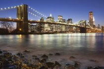Nachtansicht in Richtung Manhattan mit Manhattan Brücke über den Fluss, New York, USA. — Stockfoto