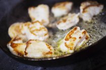 Close-up of cooked scallops in frying pan. — Stock Photo