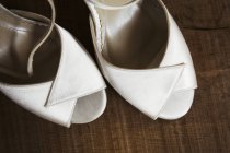 Close-up of pair of white peep-toed shoes. — Stock Photo
