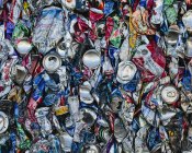 Mass of aluminium cans processed at recycling plant, full frame. — Stock Photo