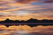 Layers of clouds reflecting in shallow water at Bonneville Salt Flats, Utah — Stock Photo