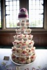 Frosted cupcakes on seven tier cake stand — Stock Photo