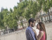 Mid adult couple looking at each other on city street. — Stock Photo