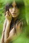 Portrait of woman with long brown hair outdoors in woodland. — Stock Photo