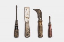 Well used tools arranged in a row on white background. — Stock Photo