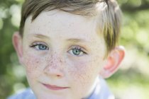 Portrait of elementary age boy with red hair, blue eyes and freckles. — Stock Photo
