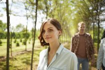 Young women and man walking on country path in summer. — Stock Photo