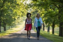 Дві жінки йдуть стежкою в заміському парку . — стокове фото