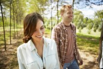 Young woman and man walking on country path in summer. — Stock Photo