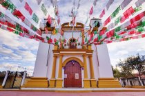 Red, white and green banners on church, Chiapas, Mexico — Stock Photo