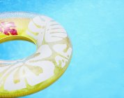 Pool inflatable ring float on blue water — Stock Photo