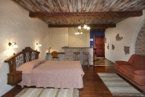 Gemütliches Bett im Hotelzimmer mit Holzdecke — Stockfoto