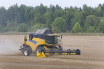 Modern combine harvester working in farm field in Estonia — Stock Photo
