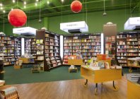 Bücher auf Regalen und Tischen im Buchladen — Stockfoto