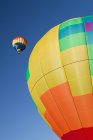 Hot air balloons in flight against blue sky — Stock Photo