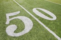 Linea di 50 yard su erba campo di football americano — Foto stock