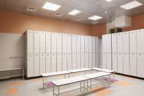 Lockers room with benches in fitness studio — Stock Photo