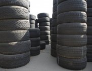 Piles of used automotive tires stacked outdoors — Stock Photo