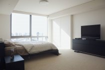 Bedroom in luxury highrise apartment interior — Stock Photo