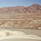 Empty bench in desert landscape in California, USA — Stock Photo