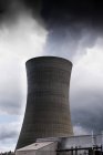 Power station cooling tower with smoke against cloudy sky — Stock Photo