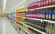 Bottled juice on supermarket shelves in England, Great Britain, Europe — Stock Photo