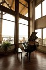 Baby grand piano in corner of living room — Stock Photo