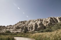Road amidst rocky landscape in sunlight, Xinjiang, China, Asia — Stock Photo